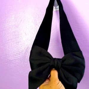 Black stretchy belt with bow and snaps to close